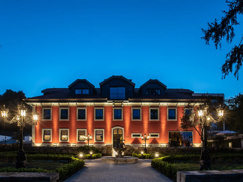 a building with a fountain and trees
